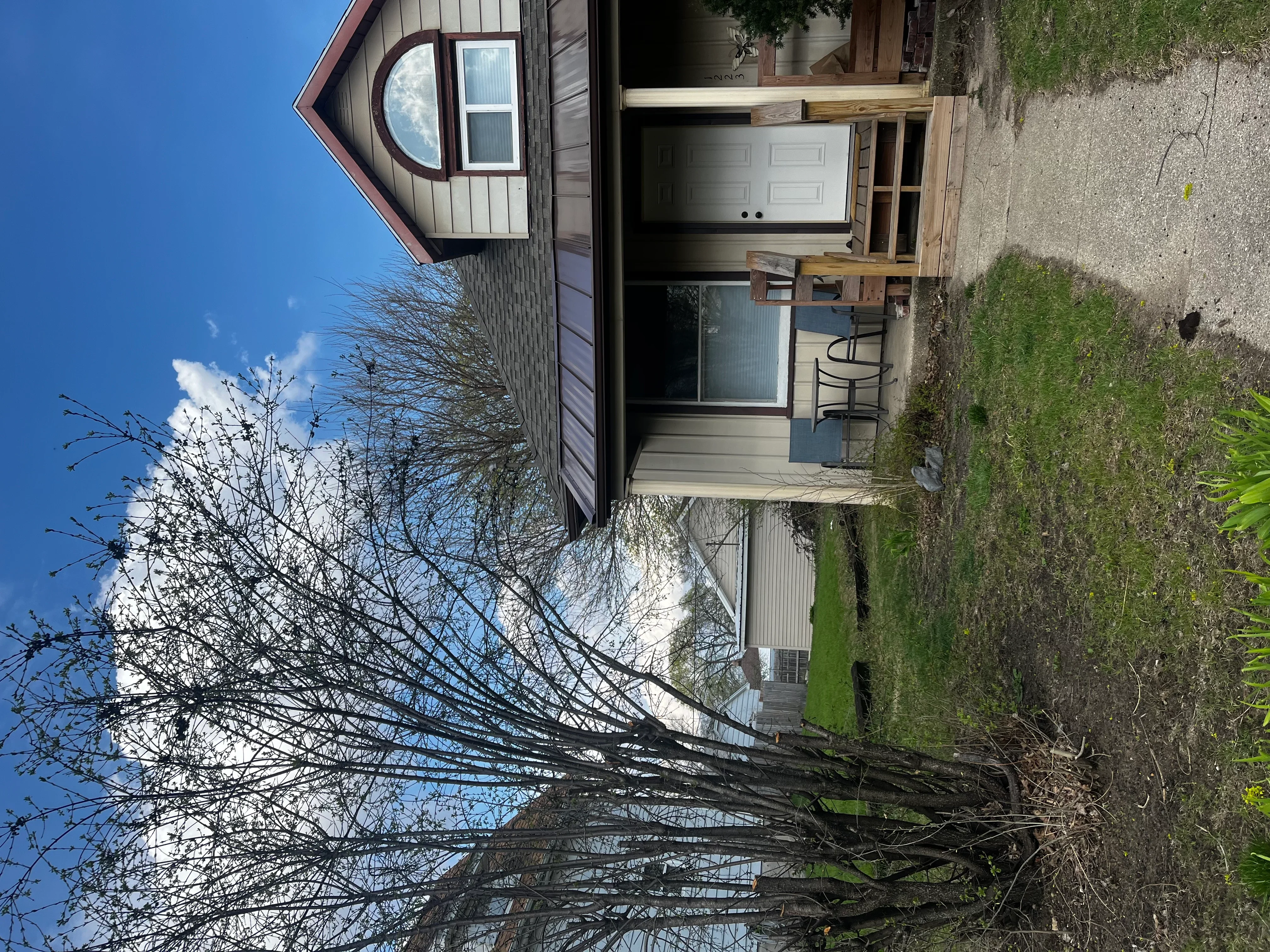 White garage door and vinyl siding on residential home exterior in Leaf River